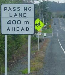 Passing lane sign on roadside.