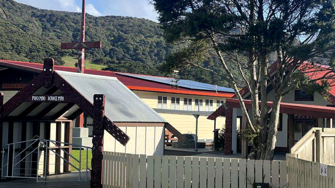 Marae buildings, one with solar panels.