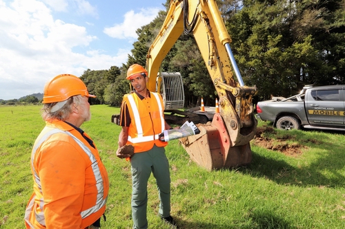 Two men near a digger.