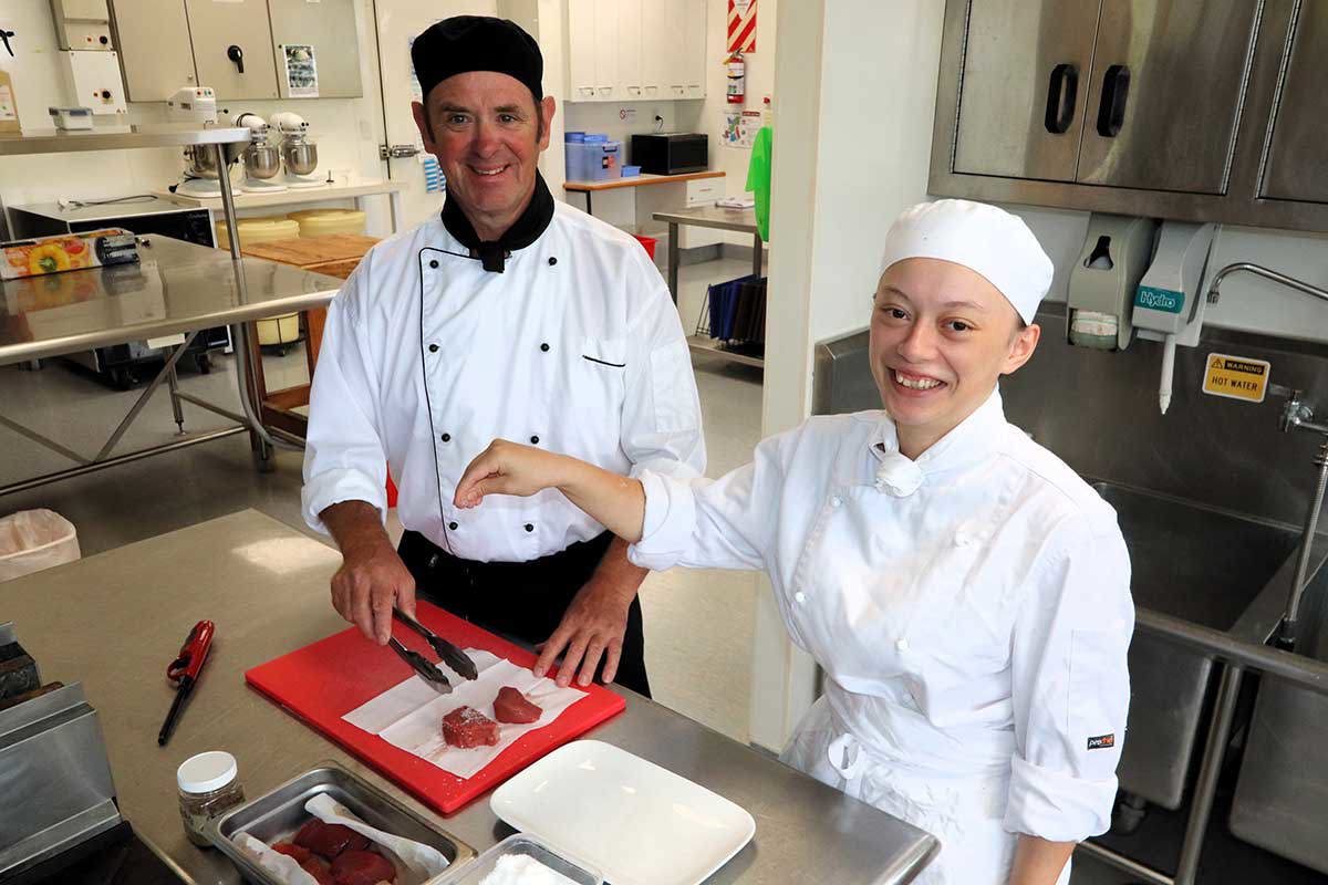 Two chefs in a kitchen.