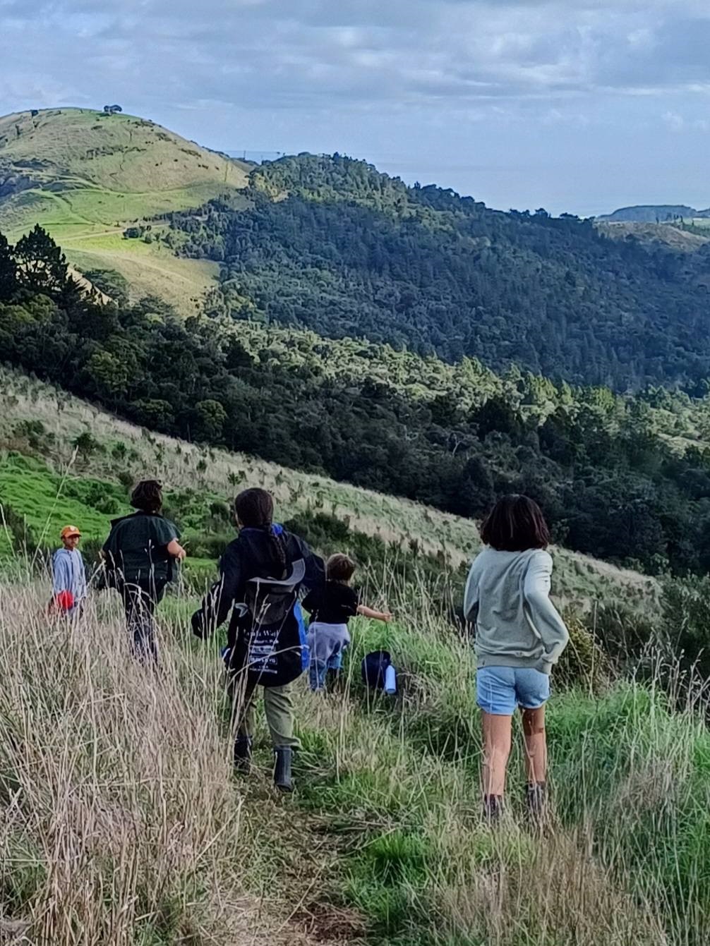 Children run through a field.