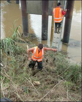 Regional Council staff installing a water level recorder.