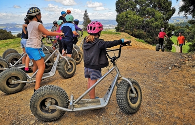 School students with scooters on the trail.