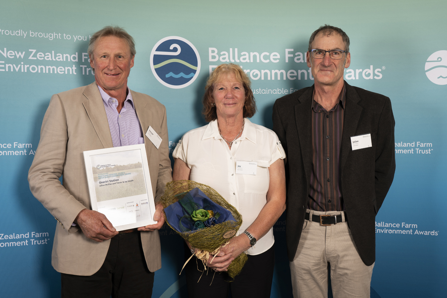 Trevor and Joy Smyth and Julian McPike of Oneriri Station holding the NRC Water Quality Enhancement Award.