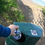 Putting rubbish into the bin.