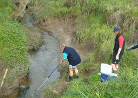 NRC Monitoring Officers taking water samples.