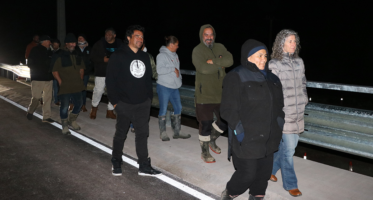 People walking on bridge.