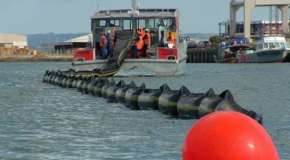 NRC boat 'Waikare' deploying a ro-boom during at oil spill response exercise.