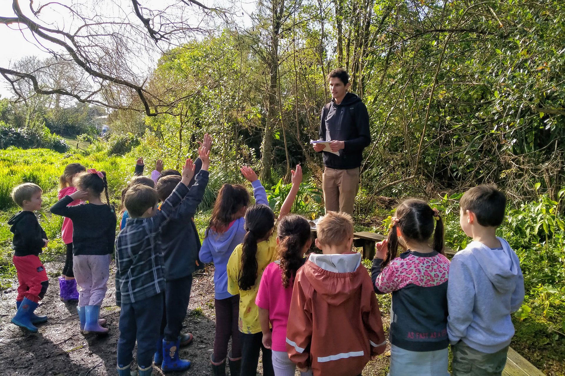 Biosecurity officer with a group of children.