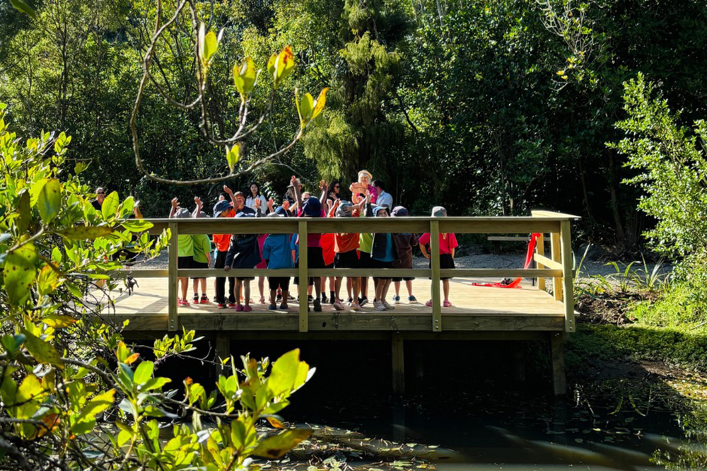 : A group of children gathered on a jetty.