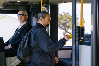 A CityLink bus passenger swiping his bee card to board the bus.