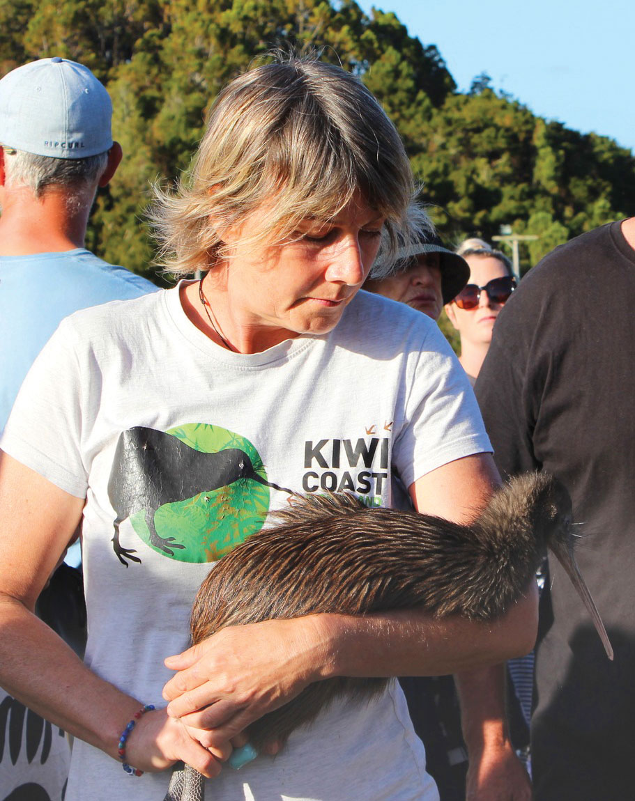 Woman holding a kiwi. (Photo: Backyard Kiwi).