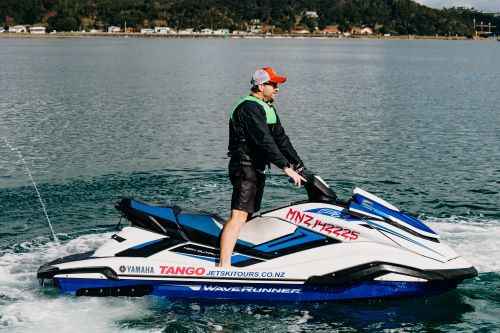 Man on jet ski with registration number displayed.