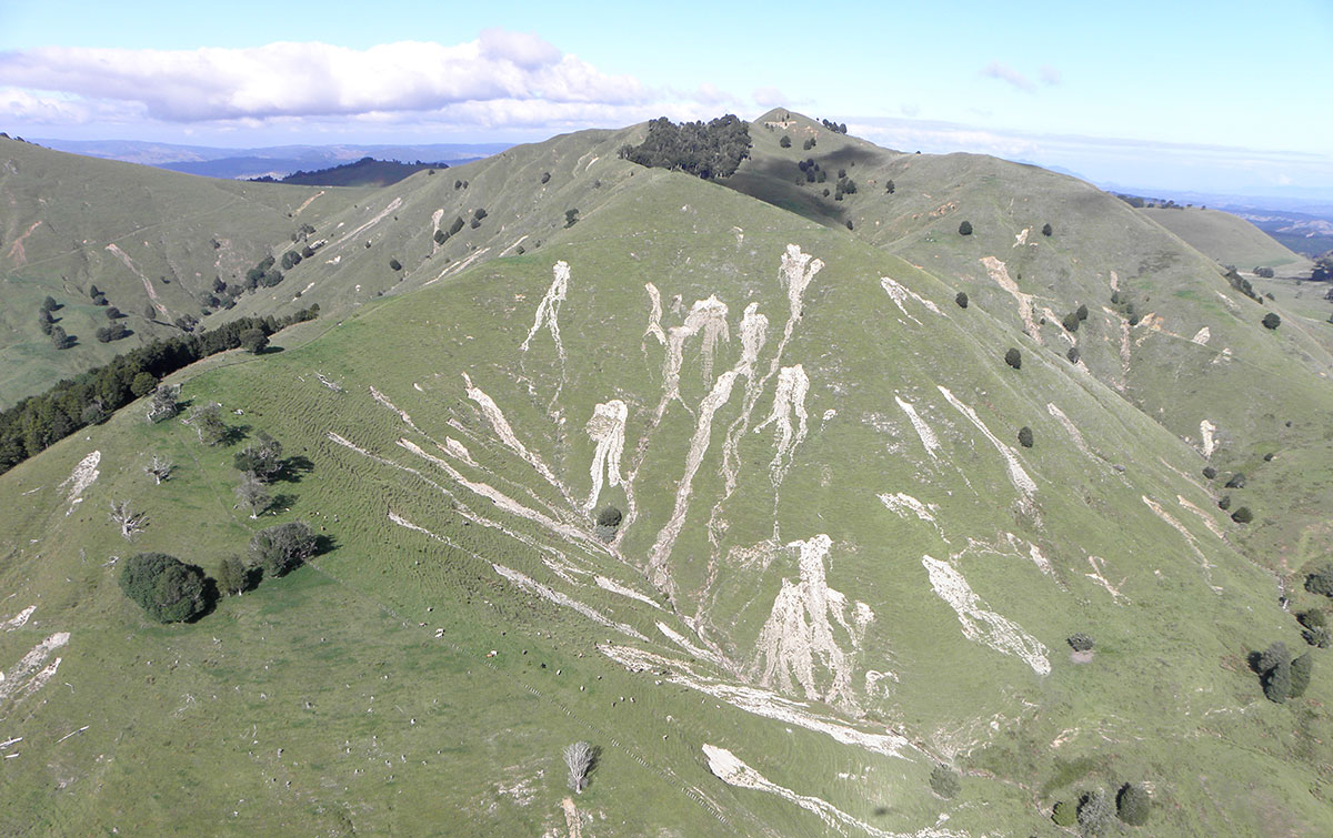 An aerial shot of erosion on hill country