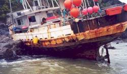 Fishing vehicle grounded on rocks.