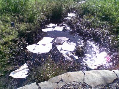 Oil spill into a stream.