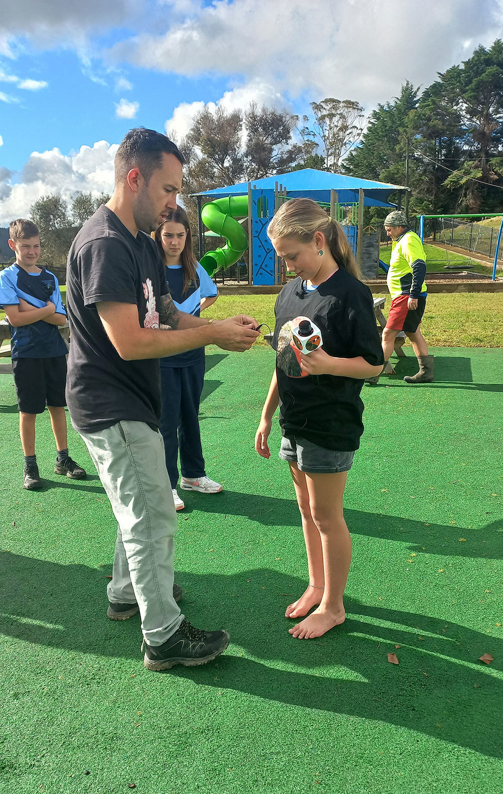 Teacher and student preparing microphone.